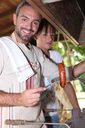 man cooking on barbecueの写真素材