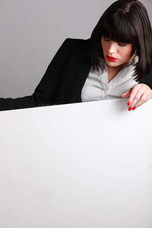 Elegant dark-haired woman carrying white signの写真素材