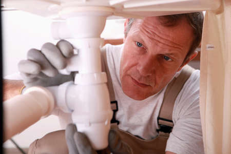 Man repairing sink for customerの写真素材