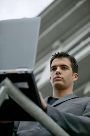 Businessman using the company laptop outdoorsの写真素材