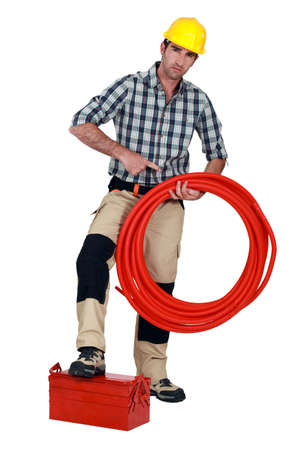 Plumber with pipes and toolboxの写真素材