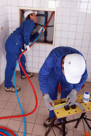 Workers  repairing pipesの写真素材