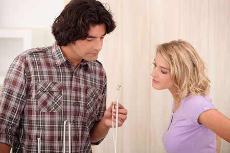 Couple at home looking at wireの写真素材