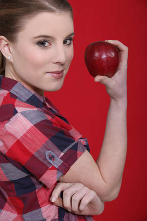 Woman with a red appleの写真素材
