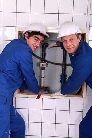 Plumber with young apprenticeの写真素材