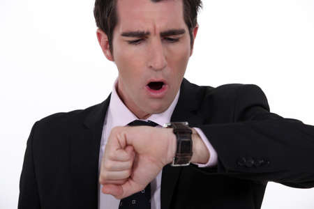 businessman in a hurry looking at his watchの写真素材
