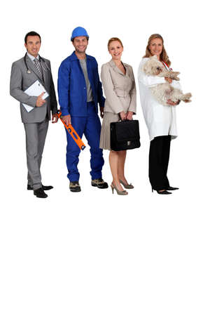 A doctor, a workman, an office woman and a vet with a dog in her arms all looking at us の写真素材