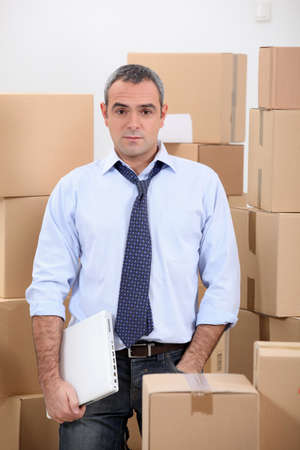 Man in storage depot surrounded by boxesの写真素材