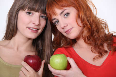Two women with applesの写真素材