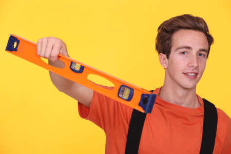 Young man with a spirit levelの写真素材