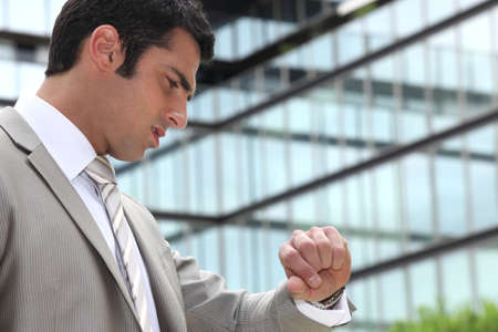Businessman looking at his watchの写真素材