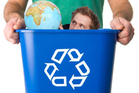Man with globe in garbage for recyclingの写真素材