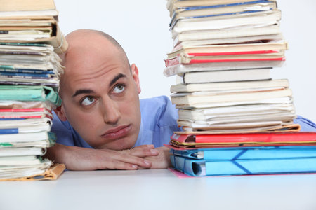 man overwhelmed with folders