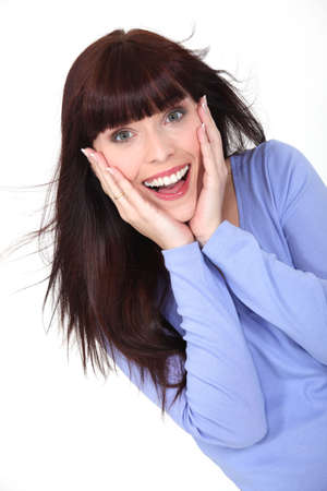 Delighted woman with her hands to her face Delighted woman with her hands to her face