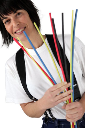 Woman holding pipe cleaners