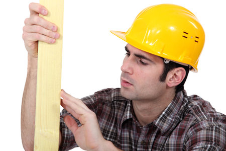 Tradesman checking the quality of his wood