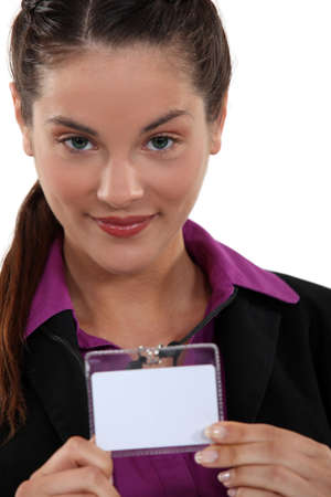 Woman displaying visitors badgeの写真素材
