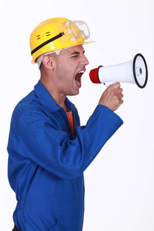 Angry builder shouting through megaphoneの写真素材