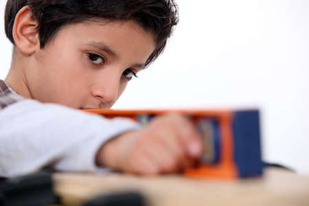 Little boy using spirit-levelの写真素材