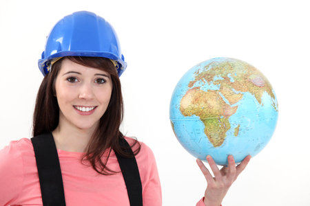 Female builder holding globe