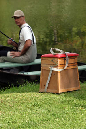 gentleman seated in boat fishingの写真素材