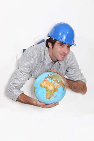 Manual worker holding globeの写真素材