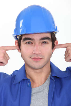 Tradesman plugging his earsの写真素材