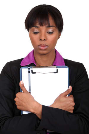 Sad woman holding a clipboardの写真素材