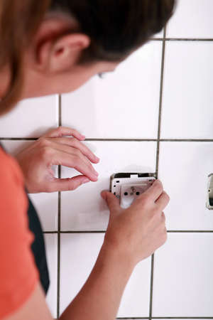 Female electrician installing a jackの写真素材