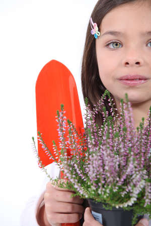little girl with shy smile gardeningの写真素材
