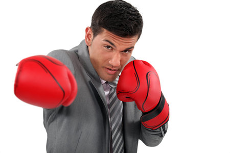 Businessman wearing boxing gloves