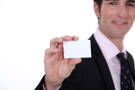 Man presenting business cardの写真素材