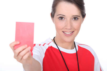 female soccer referee holding out red cardの写真素材