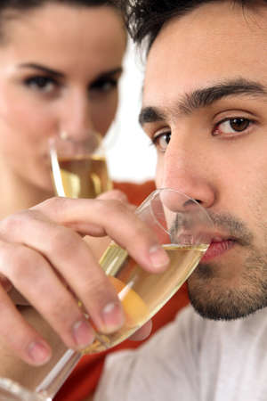 Couple drinking from flutesの写真素材