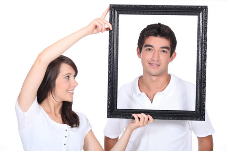 Couple stood with empty picture frame