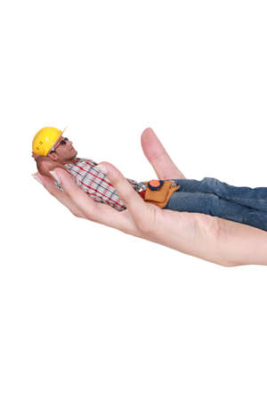 Character laid in a hand of a womanの写真素材