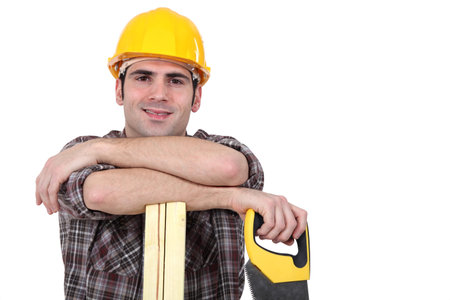 Mason holding handsaw and plank of wood
