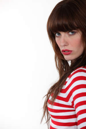 Gorgeous brunette standing on white backgroundの写真素材