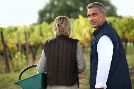 Couple tasting wine in the vineyard