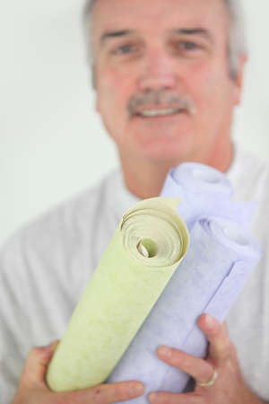 Man holding selection of wallpaperの写真素材