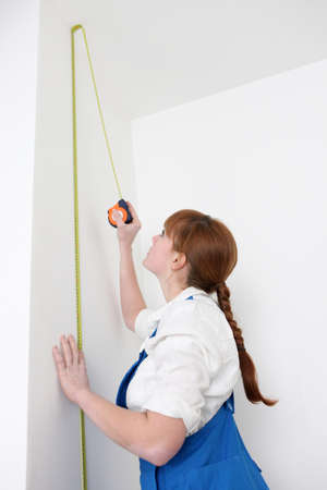 woman measuring wallの写真素材