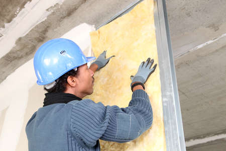 Man fitting wall insulationの写真素材