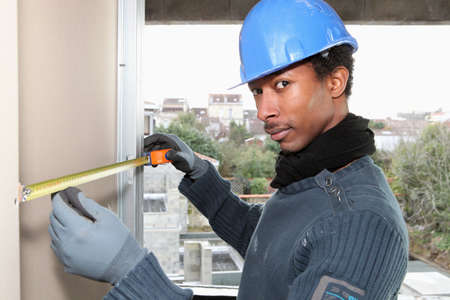 Manual worker measuring interior wallの写真素材