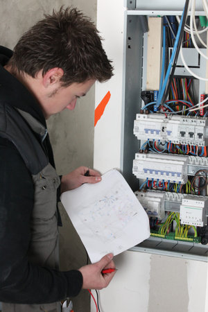 Electrician with sketch of electrical panel
