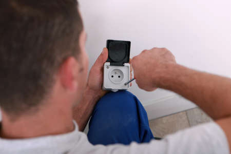electrician repairing an electricity socketの写真素材