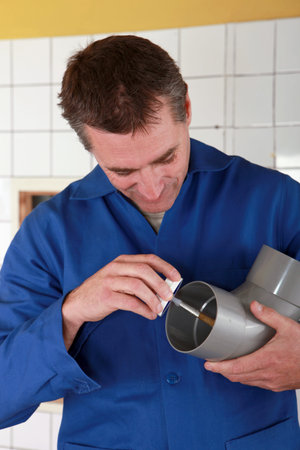 Plumber preparing plastic pipe
