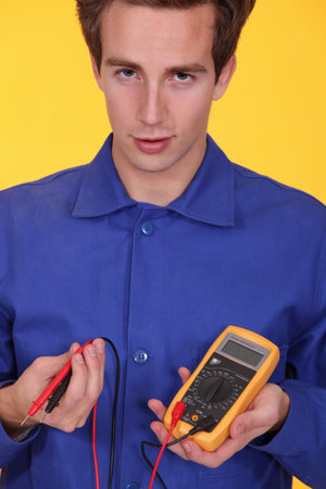 Young man with a multimeter