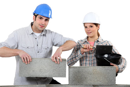 Man and woman building a house