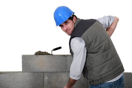 A mason building a wall.