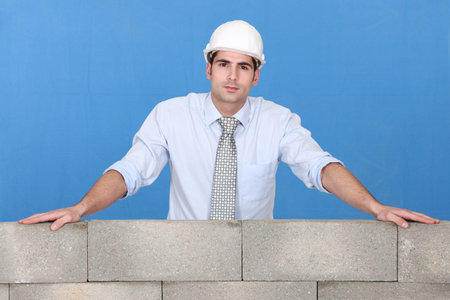 Engineer standing over a stone wall
